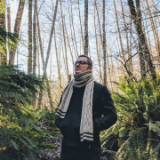 Photo of Luke Marney in forest among ferns.